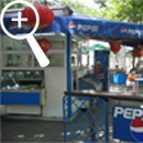 Photo 30: Blue Pepsi signs around a cafe area.