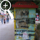 Photo 4: Side view of yellow kiosk covered in graffiti.