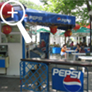 Photo 8: Blue Pepsi signs around a cafe area.