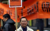 Man holding sign protesting agent orange
