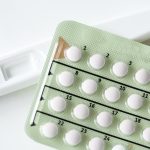 Closeup of pregnancy test and contraceptive pills birth control concept