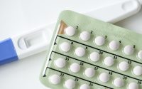 Closeup of pregnancy test and contraceptive pills birth control concept